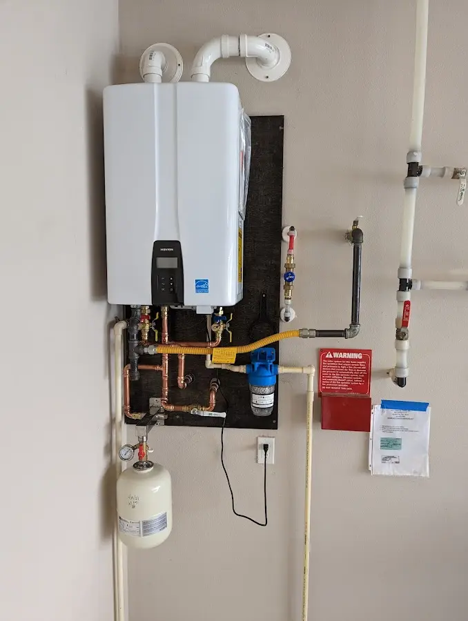 Professional plumber installing copper piping in a East Coventry home